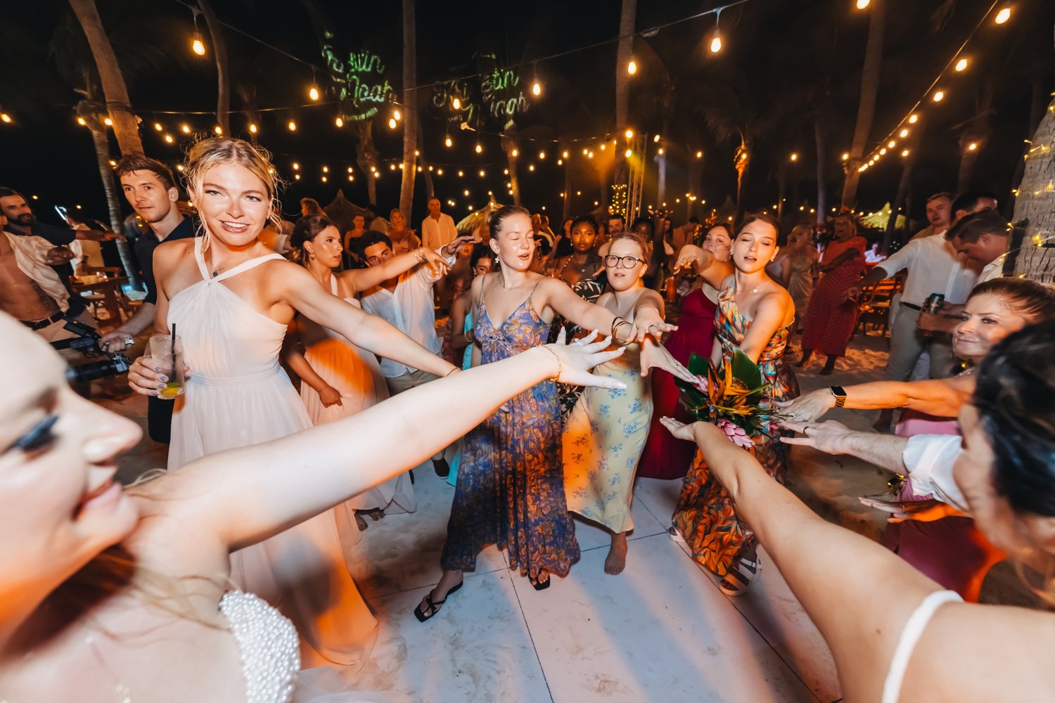 Wedding guests surrounding a bride on the dance floor