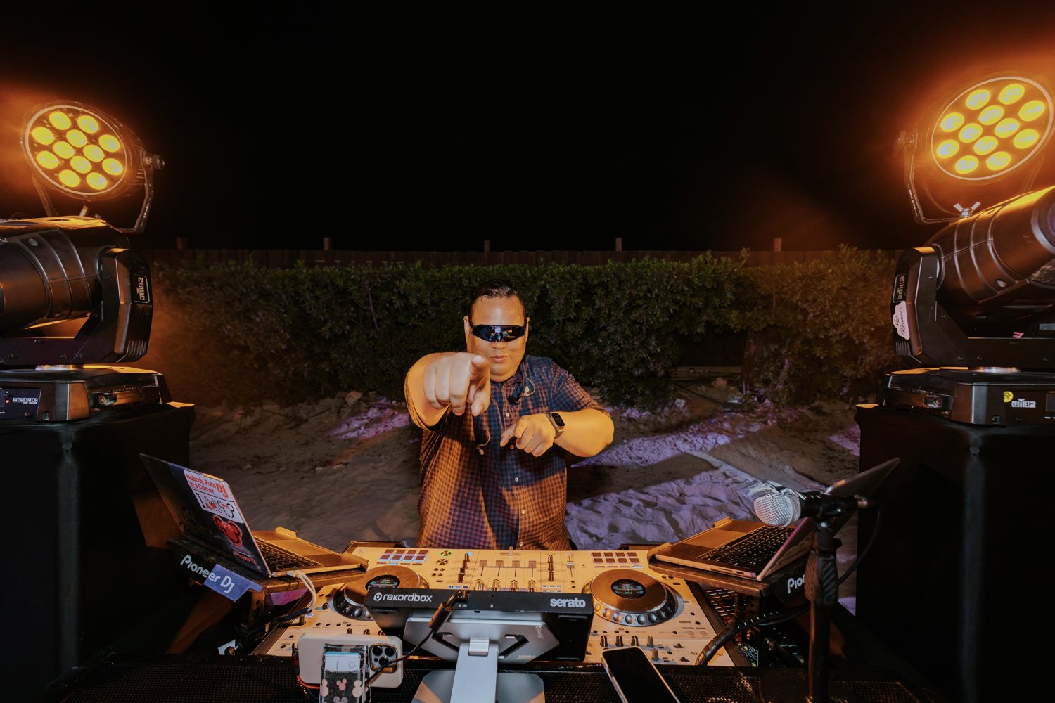 Ruuben pointing toward the camera from behind his DJ controller